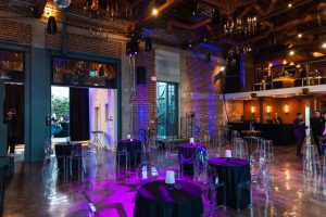 best indoor wedding venues in california Indoor event reception setup with purple uplighting and modern decor.