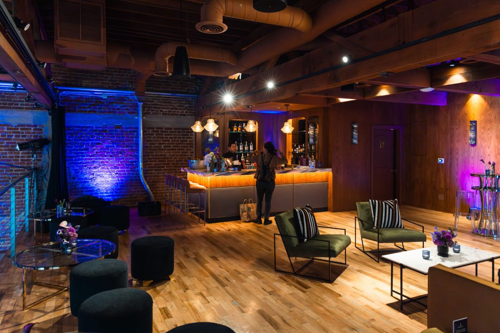 best indoor wedding venues in california Cozy indoor lounge setup with warm lighting and elegant decor for wedding reception.